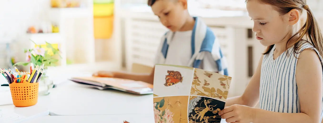 Children reading a book together