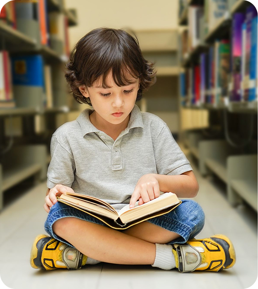 Child reading a book in library